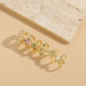 Close-up of a 5-piece gold-plated ring set featuring pearls, gems, and a dragonfly motif