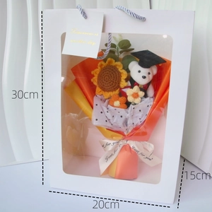 Handmade crochet bouquet gift box with sunflower and teddy bear in graduation cap