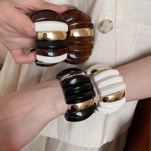 Detail of chunky acrylic resin bangle showing bold rectangular color-block pattern