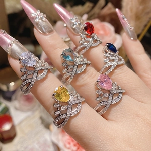 Close-up of 18K gold plated rings with pear-cut gemstones on model's hand