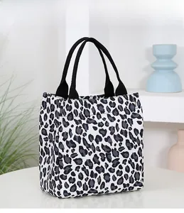 Detail of stylish black and white leopard print canvas tote bag with black strap handles