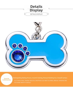 Macro detail of bone-shaped pet tag with blue epoxy coating and claw-set rhinestones