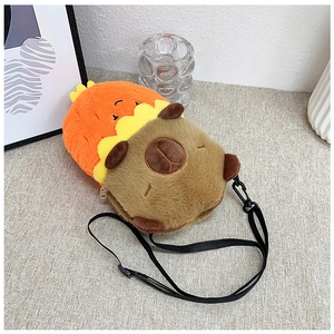 Close-up of a cute plush capybara crossbody bag made of soft brown fabric on a beige background