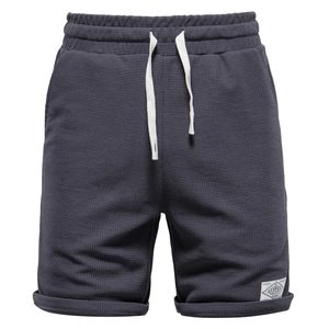 Men's dark grey waffle knit drawstring shorts with elastic waistband in a flat lay view