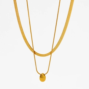 Detail of gold double-layer necklace with water drop pendant and flat snake chain