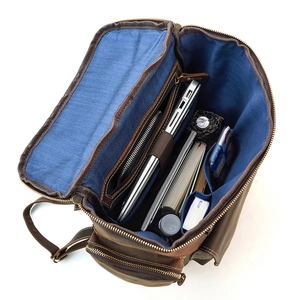 Internal view of brown leather backpack with laptop compartment and blue lining
