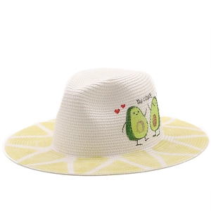 White woven sun hat with avocado embroidery and yellow striped brim for beach vacation