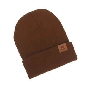 Detailed knit texture of a brown winter beanie with a leather logo patch M engraving