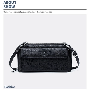 Close-up of black litchi pattern leather cross-body phone bag with silver hardware detail