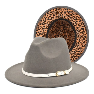 Detail view of grey fedora hat with leopard print lining and white buckle belt