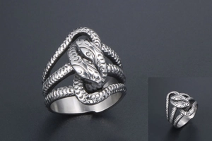 Macro detail of antique silver snake ring showing intricate relief scales and texture