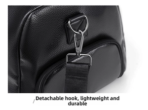 Detail of detachable gun-metal hook on black pebble leather travel bag with nylon strap