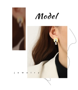 Detailed close-up of gold and silver plated serpent style hoop earrings with pavé crystals