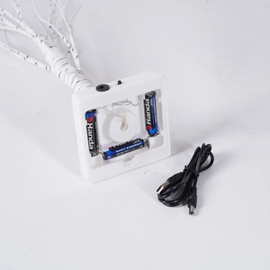 Detail of white tree light base with AA battery compartment and USB DC power cable