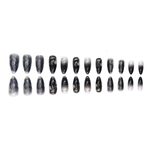Press-on nails set with black and grey cat-eye marble designs on long almond nails
