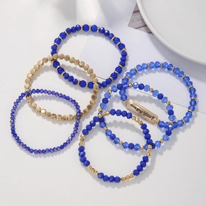 Détail de perles de cristal bleu et de bracelets dorés en ensemble de 6 pièces