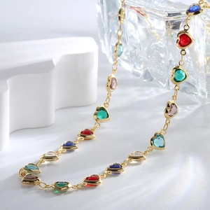 Golden necklace with multicolored heart-shaped zircon stones in a luxury minimalist style