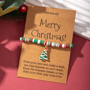 Christmas polymer clay bead bracelet with festive tree pendant on a kraft wish card