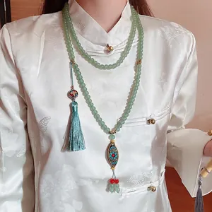 Vintage Chinese style necklace with pale green beads, bronze pendant and blue silk tassel