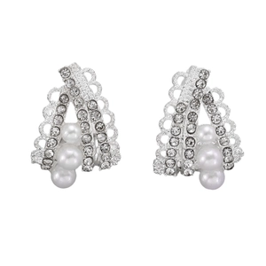 Detailed view of silver lace hollow earrings with sparkling rhinestones and white pearls