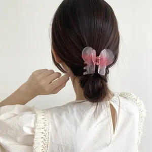Pink gradient heart hair claw clip shown in an elegant half-up hairstyle