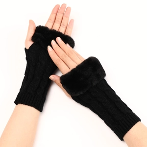 Detailed knit texture of black fingerless gloves with luxurious faux fur trim