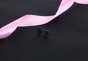 Close-up of black S925 silver druzy stud earrings with shimmering crystal texture