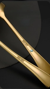 Macro detail of gold SUS 304 stainless steel spoon handle with engraved material mark