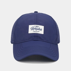 Macro detail of breathable laser-cut side vents on quick-dry navy baseball cap