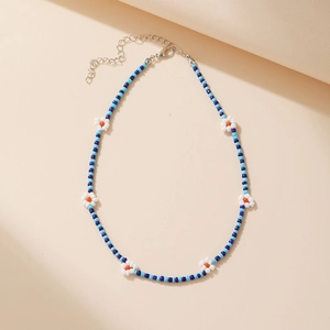 Detail of Bohemian seed bead choker with blue and white flowers and silver lobster clasp