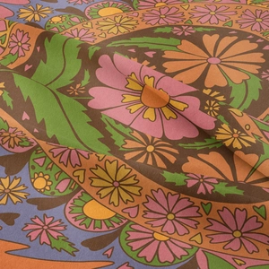 Close-up of retro bohemian floral tapestry showing detailed sunflower fabric texture