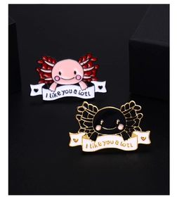 Macro shot of cute pink and black axolotl enamel pins with I like you a lotl text