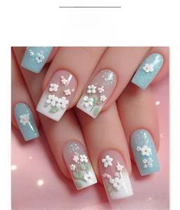 Detail of 3D white floral patterns on blue gradient long square press-on nails