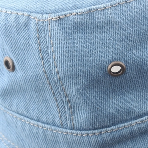 Light blue washed denim bucket hat with durable stitching and metal ventilation eyelets