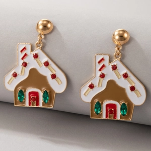 Close-up of gingerbread house earrings with red and green rhinestones on gold base