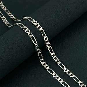 Macro shot of silver Figaro chain showing high-polish 3+1 link details and texture