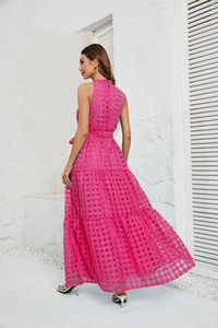 Detail view of rose pink halter neck maxi dress showing back profile and layered hemline