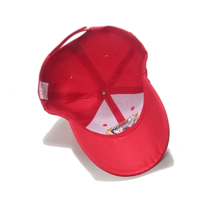 Detail view of red baseball cap interior with acrylic fabric label and six-panel stitching