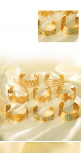 Detailed macro view of 18K gold plated stainless steel bangles with floral and leaf motifs