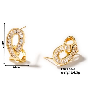 Detailed view of gold twisted knot earrings with trapezoidal cubic zirconia stones and sizing