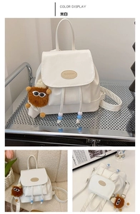 Detail of off-white PU leather backpack with drawstring closure and plush monster charm