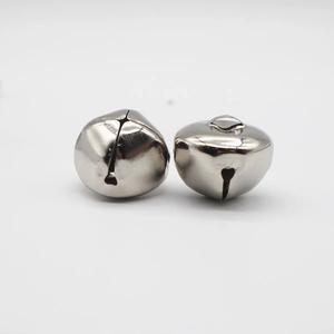 Pair of nickel-plated metal bells with cross cutout and top loops on white background