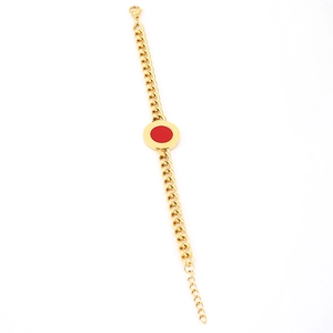 Detailed close-up of thick gold Cuban chain bracelet with a red round enamel pendant