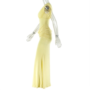 Detail of light yellow ruched sleeveless dress showing side drawstring and slim fit texture