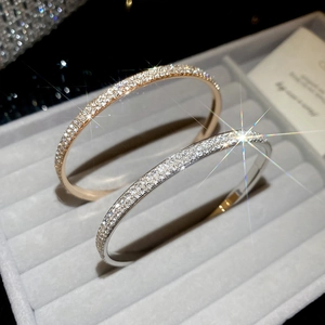 Detailed close-up of rose gold and silver pavé bracelets with sparkling cubic zirconia