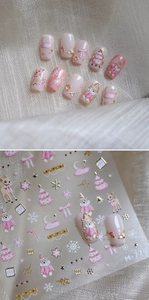 Detail showing pink Christmas nail stickers with bear, elk and snowflake patterns
