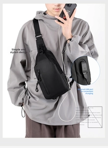 Detail of water-resistant black chest bag for men showing external USB charging port feature