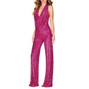 Detail of fuchsia sequin wide-leg jumpsuit featuring halter neck and deep V-neckline