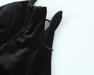 Detail of hidden side zipper on black velvet bodysuit with high-quality fabric texture