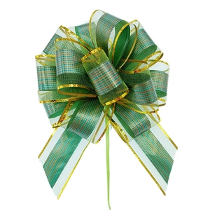 Detail of green and gold plaid organza ribbon bow with metallic edges on white background